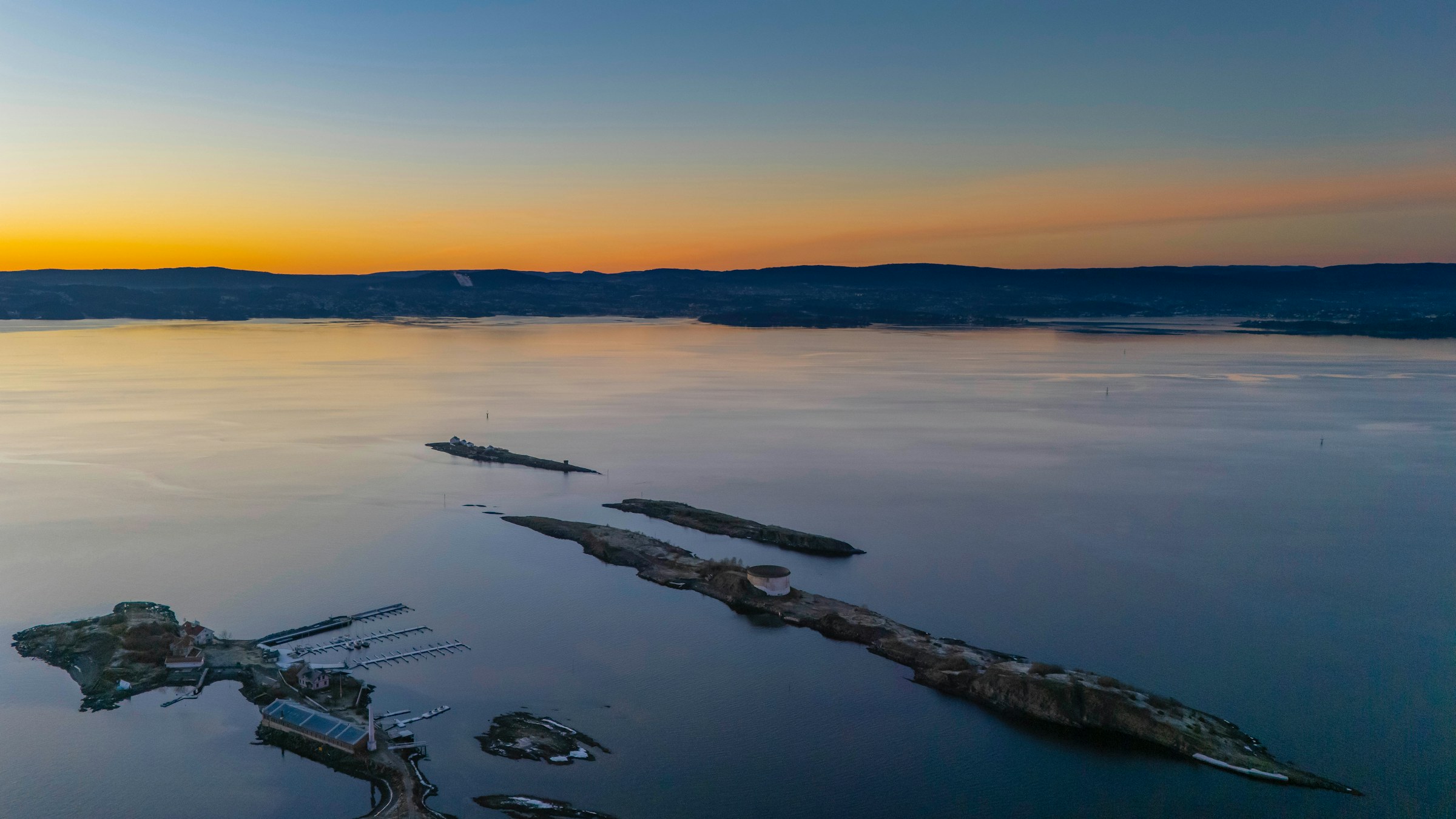 Calm water at dusk, viewed from a small marina